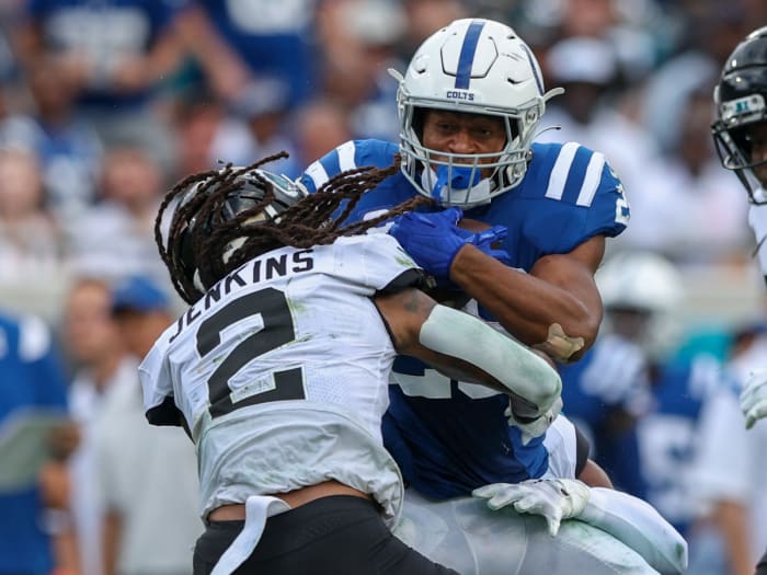 Jonathan Taylor is tackled by a Jaguars defender